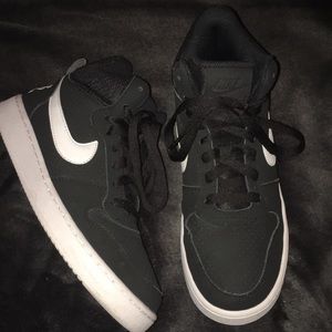 High top black and white Nike sneakers.